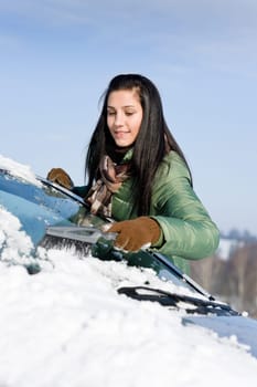 Winter car - woman remove snow from windshield