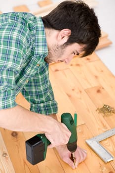 Home improvement - handyman installing wooden floor