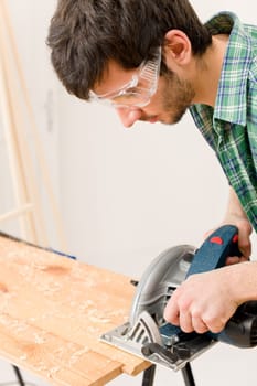 Home improvement - handyman cut wood with jigsaw