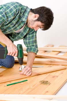 Home improvement - handyman installing wooden floor