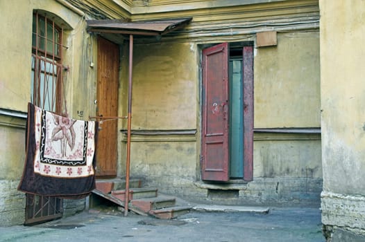 Doorway to old apartment building in city outskirts