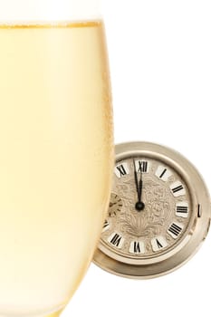 Cold glass of sparkling wine in front of pocket watch