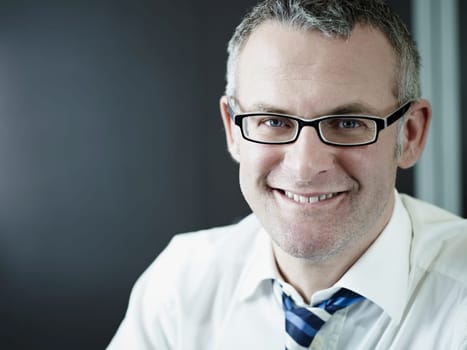 confident businessman smiling at camera