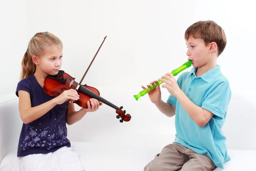Kids playing flute and violin