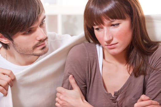 man and ill woman at home