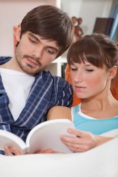 couple reading book in bed