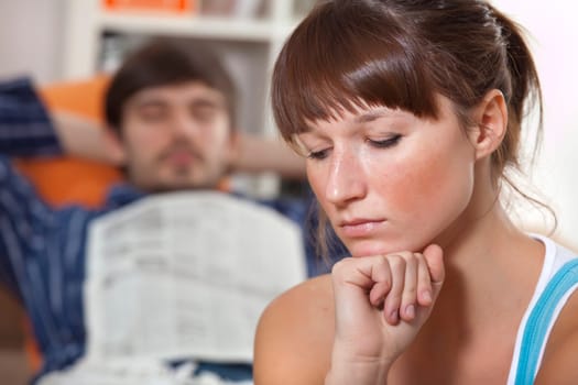 sad woman and lazy man in bed