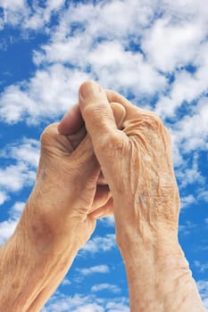 Senior woman - hands over blue sky