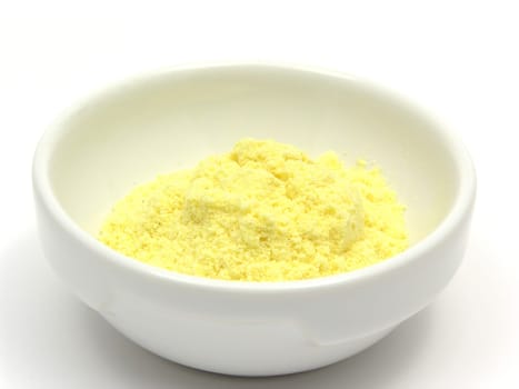 Corn flour in a porcelain bowl on white background