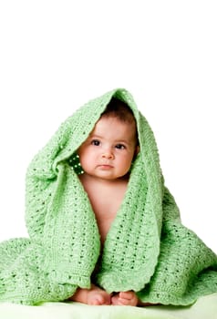 Cute baby sitting between green blanket