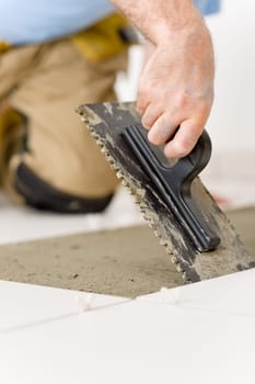 Home improvement, renovation - handyman laying tile