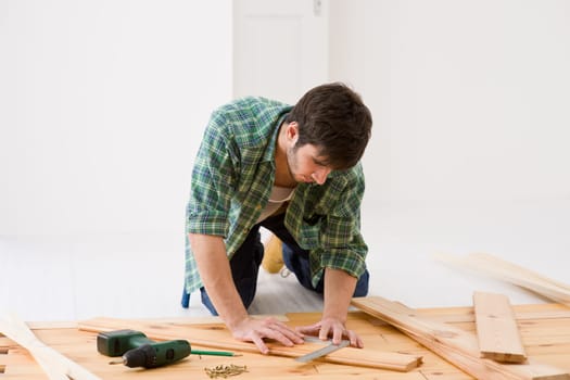 Home improvement - handyman installing wooden floor