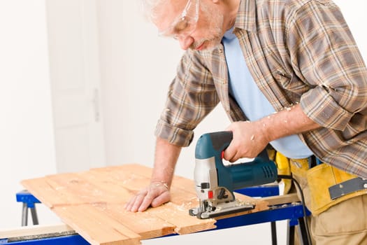 Home improvement - handyman cut wood with jigsaw