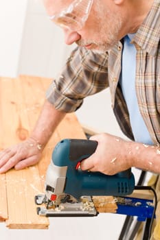 Home improvement - handyman cut wood with jigsaw