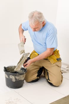 Home improvement, renovation - handyman laying tile