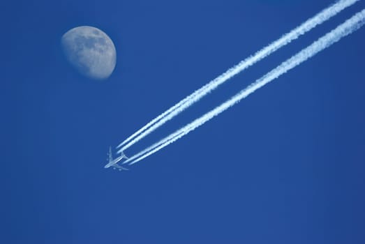 Airplane in the sky with moon