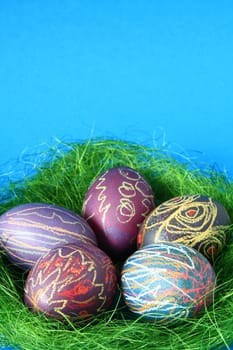 five brightly colored Easter eggs