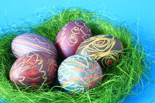 five brightly colored Easter eggs