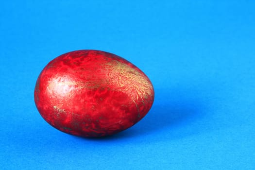Red egg on blue background