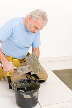 Home improvement, renovation - handyman laying tile