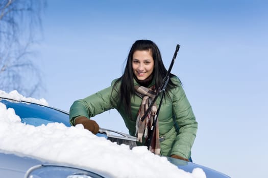 Winter car - woman remove snow from windshield
