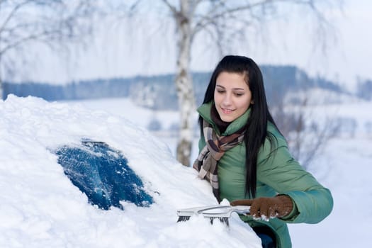 Winter car - woman remove snow from windshield
