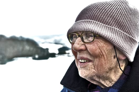 old woman in front of winter landscape