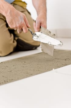 Home improvement, renovation - handyman laying tile