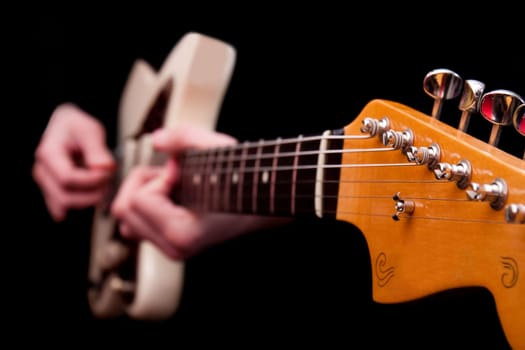 Hands playing guitar string music