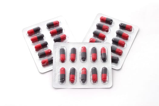 Drugs in a blister pack over a white background.