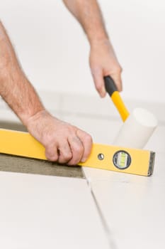 Home improvement, renovation - handyman laying tile