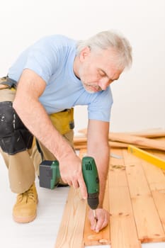 Home improvement - handyman installing wooden floor