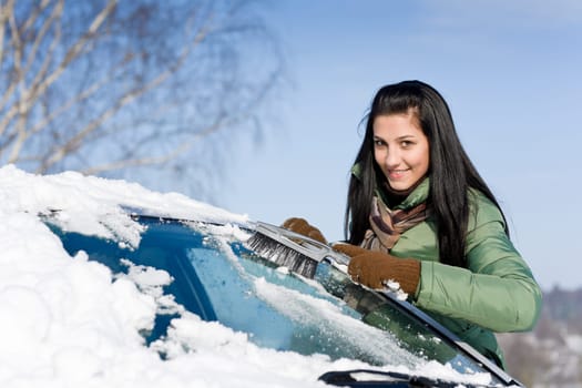 Winter car - woman remove snow from windshield
