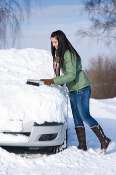 Winter car - woman remove snow from windshield