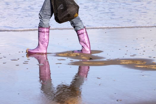 Walk on the beach in rubber boots