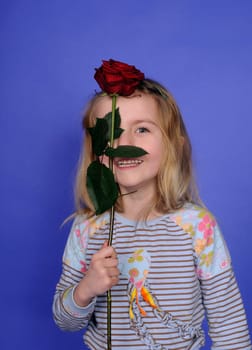 Little girl with red rose