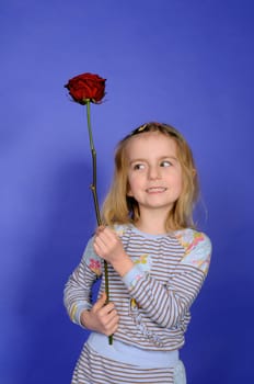 Little girl with red rose