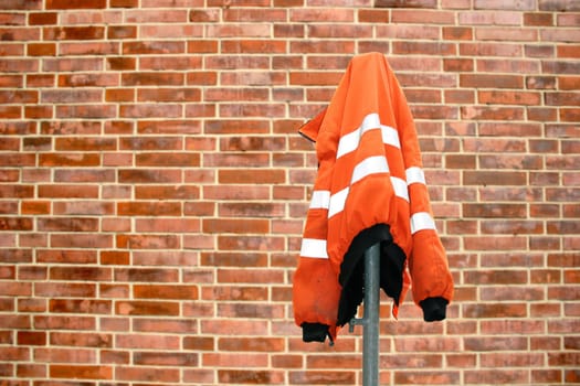 Construction site work jacket from brick wall