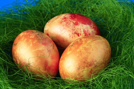 three golden yellow Easter eggs