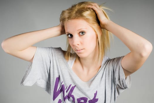 Girl with hands on her head
