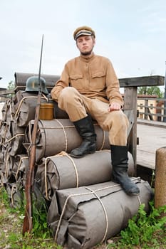 Soldier with helmet and gun sitting on t