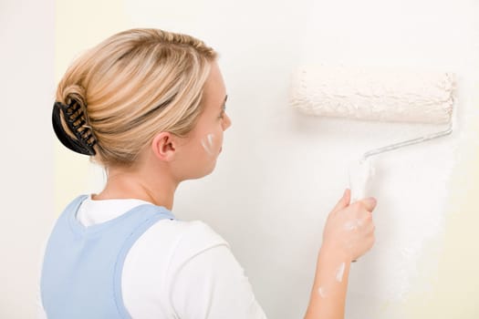 Home improvement - handywoman painting wall