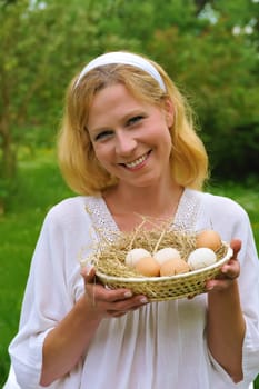 Young woman holding fresh eggs