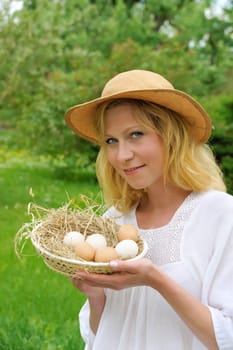 Young woman holding fresh eggs