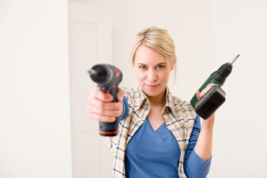 Home improvement - woman with battery screwdriver