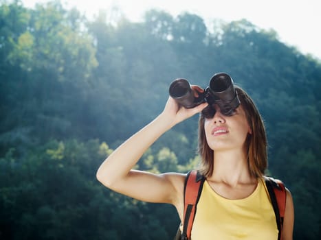woman hiking with binoculars