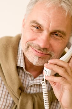 Happy senior mature man on the phone