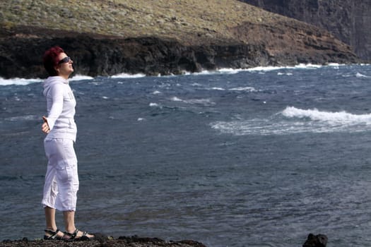 Woman in the wind by the sea