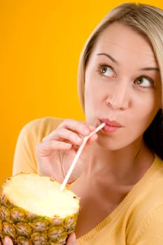 Healthy lifestyle - woman drink juice from pineapple