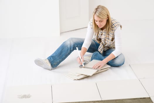 Home improvement - handywoman measuring tile